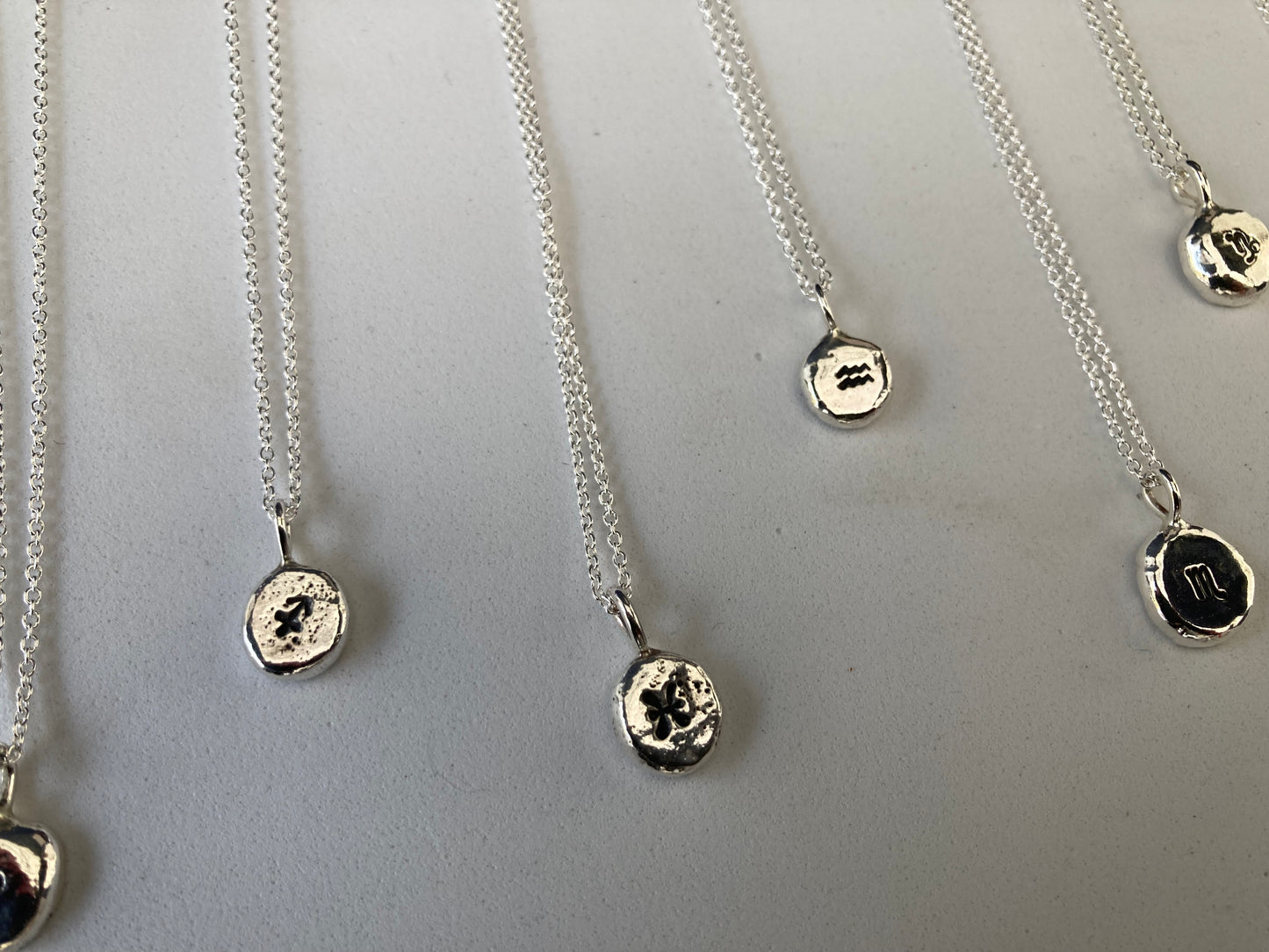 Star sign silver pebble pendants