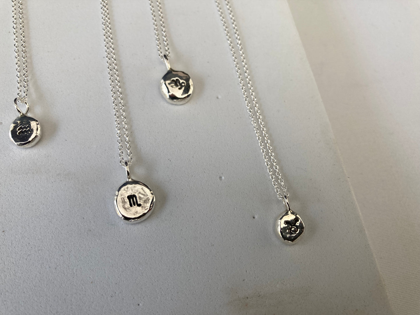 Star sign silver pebble pendants