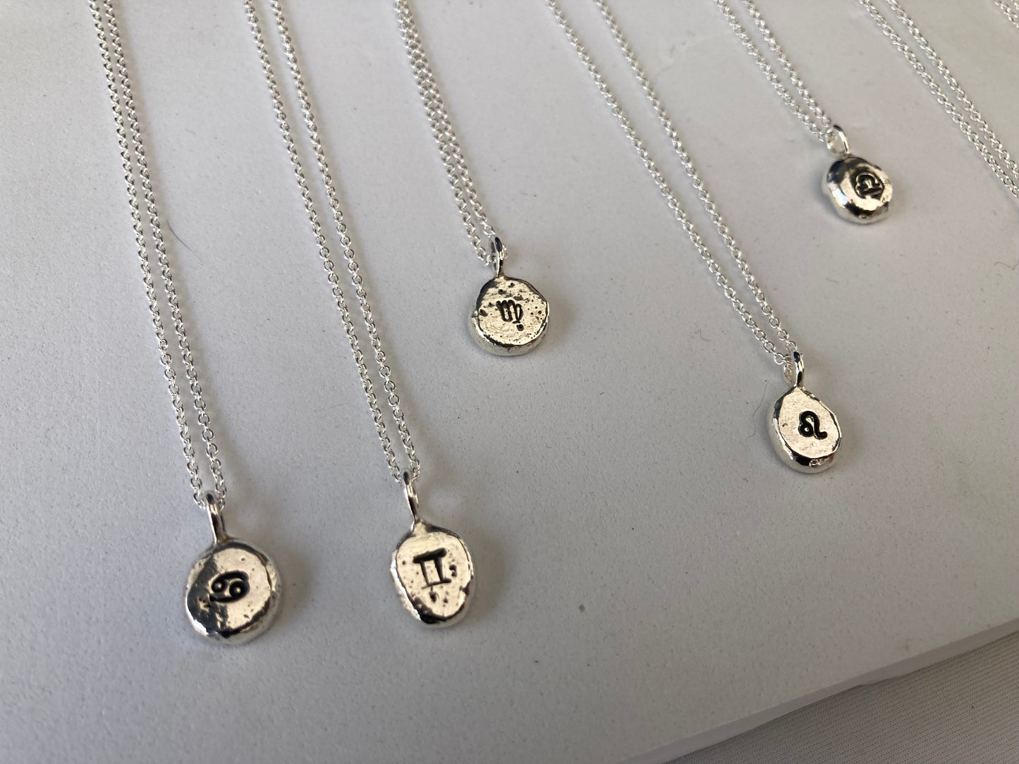 Star sign silver pebble pendants