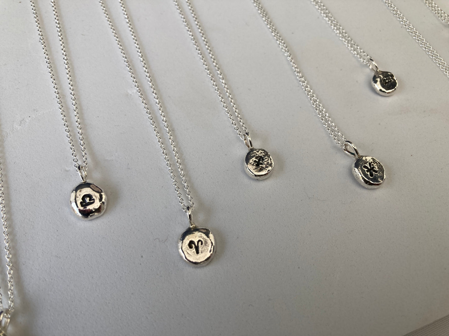 Star sign silver pebble pendants
