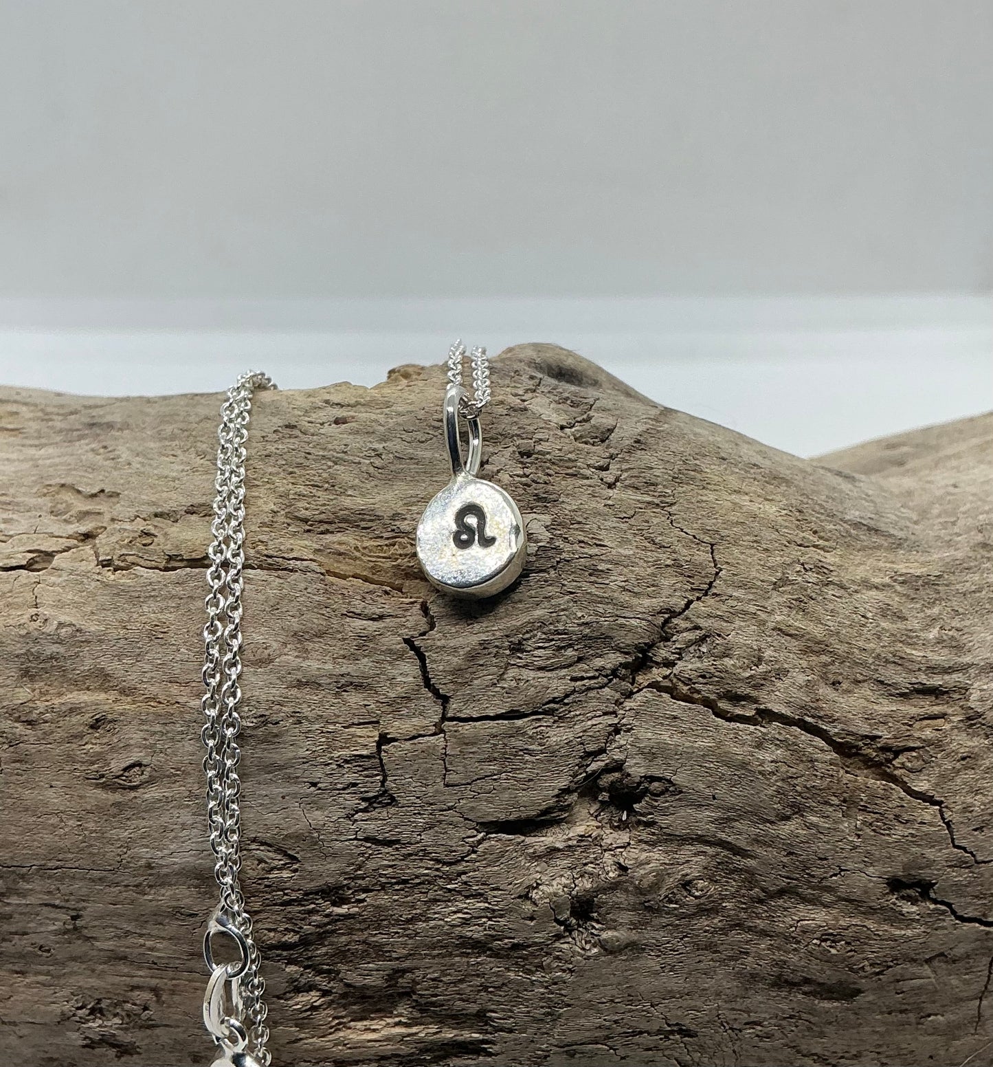 Star sign silver pebble pendants